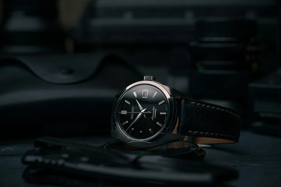 A YELM watch resting on a watchmaker's bench.