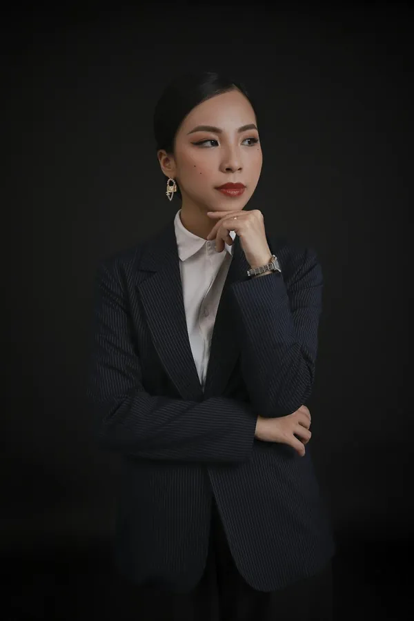 A woman in a navy suit wearing a YELM watch.