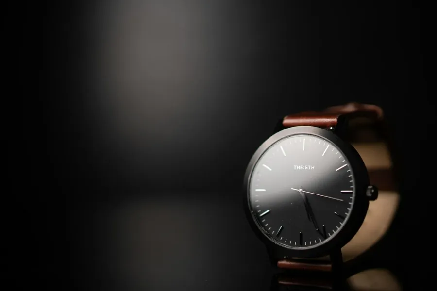 Veris Black — a dark-dial YELM watch on a cognac leather strap.